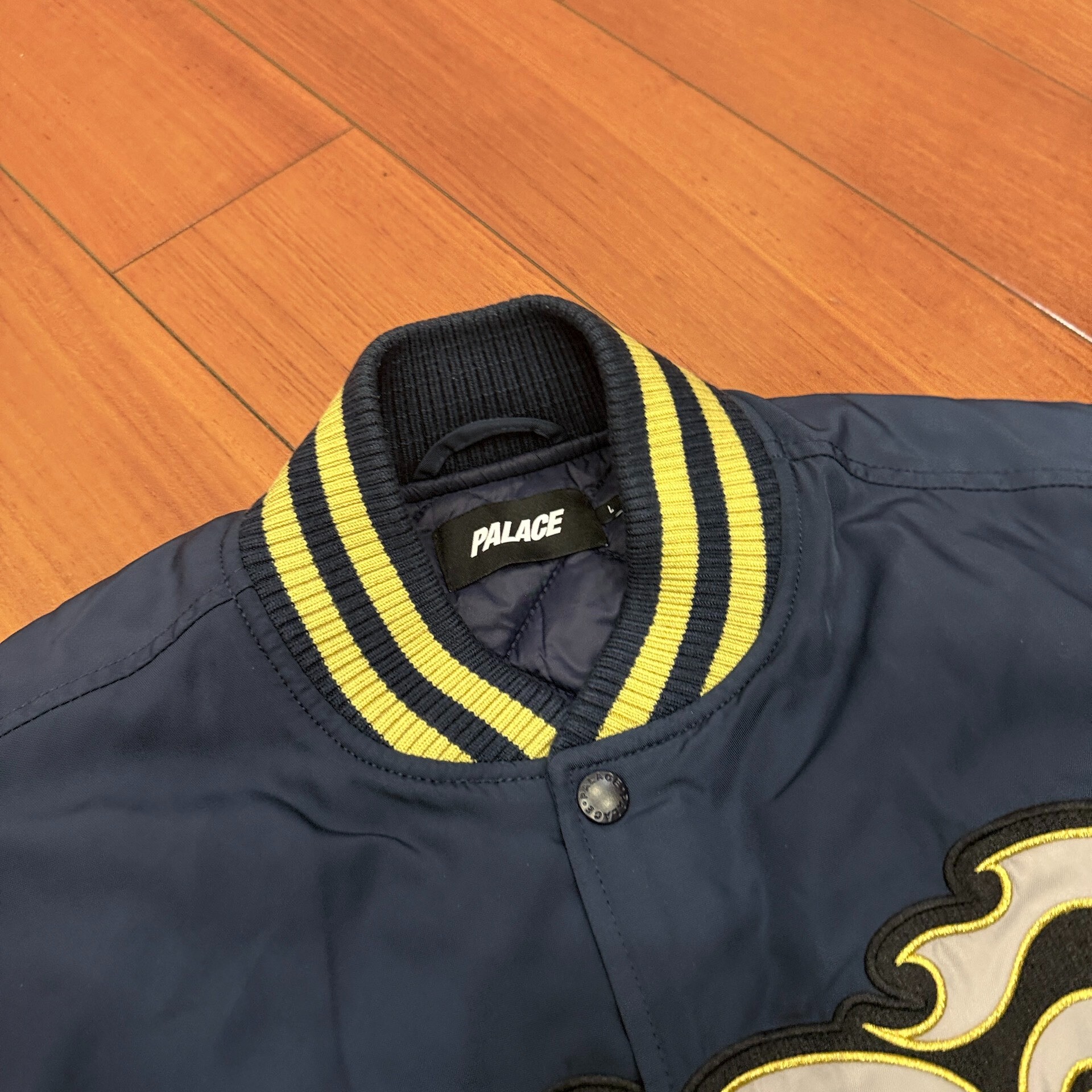 Palace FW25 Muay Navy Varsity Jacket — label
