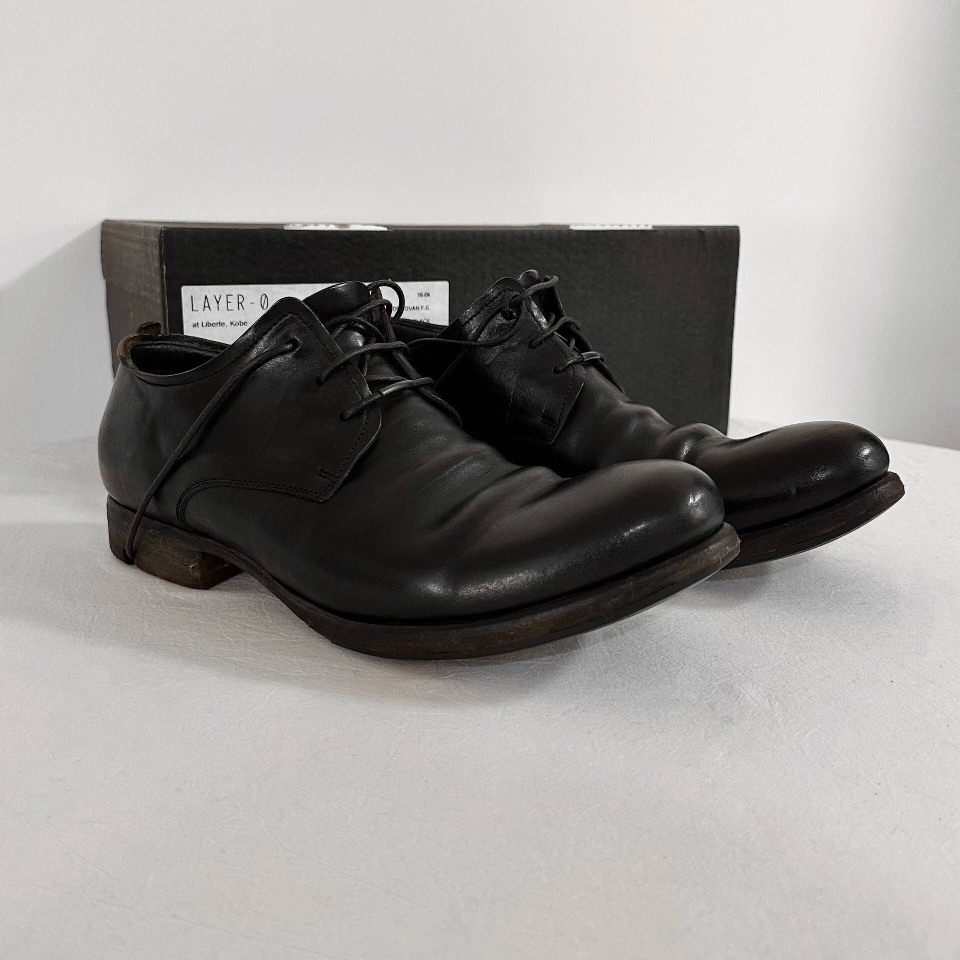 LAYER-0 Black Cordovan Derby Shoes — front