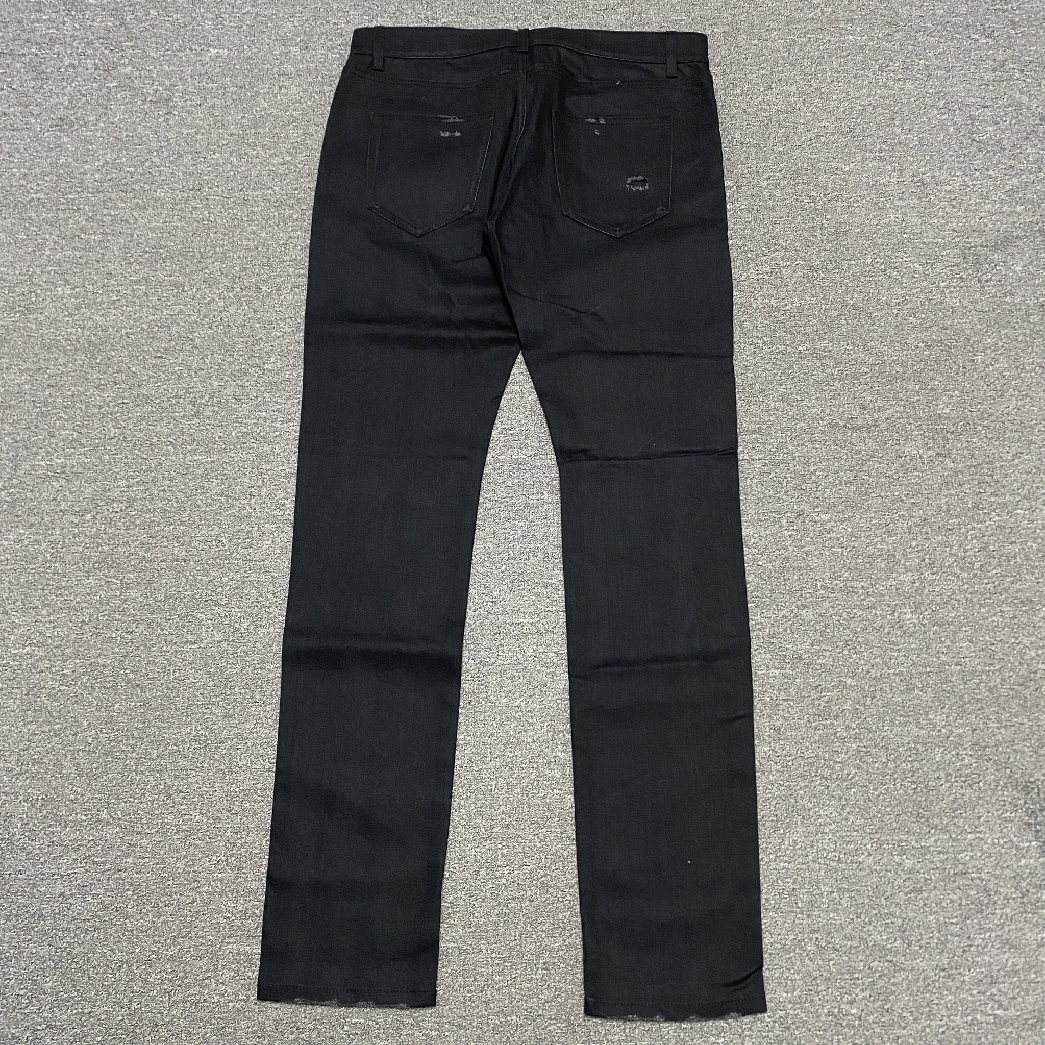 Saint Laurent Distressed Denim Jeans — detail