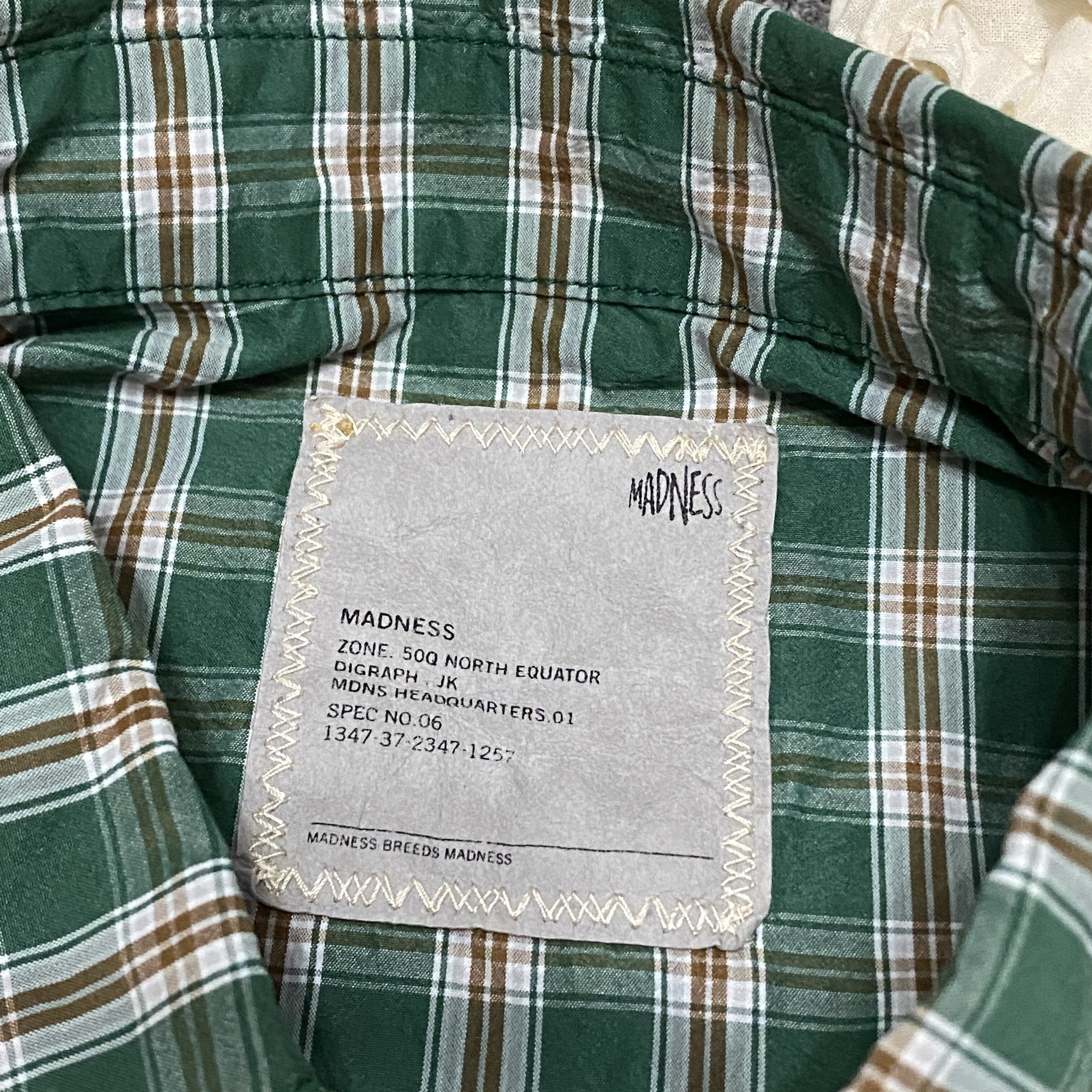 MADNESS 24SS Green Plaid Shirt — label