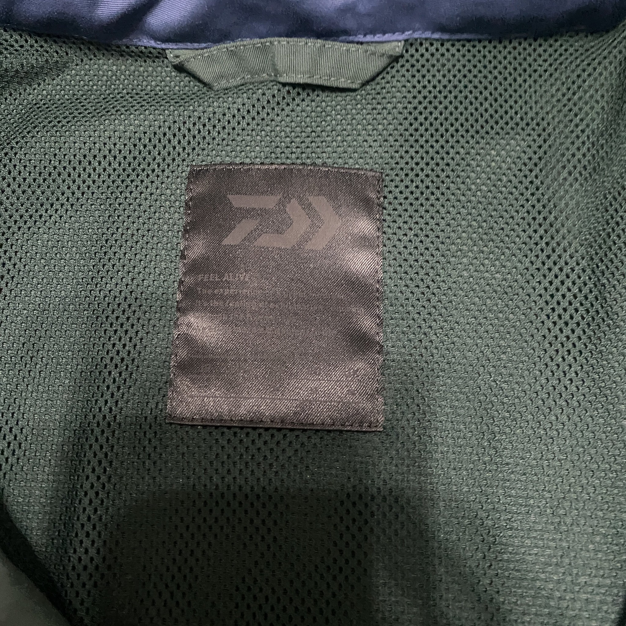 DAIWA PIER39 22SS Multi-Pocket Jacket — label