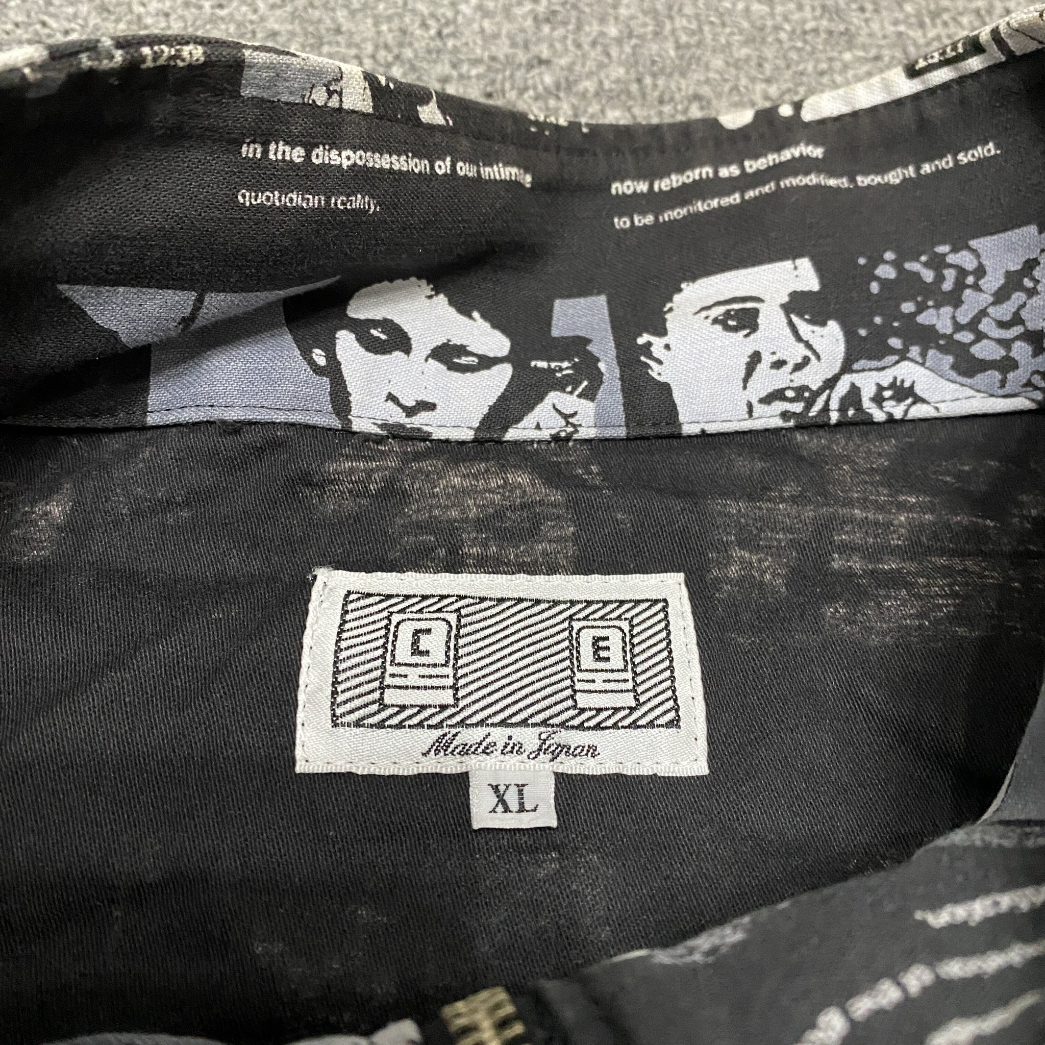 CAVEMPT Full-Face Print Zip-Up Jacket — label