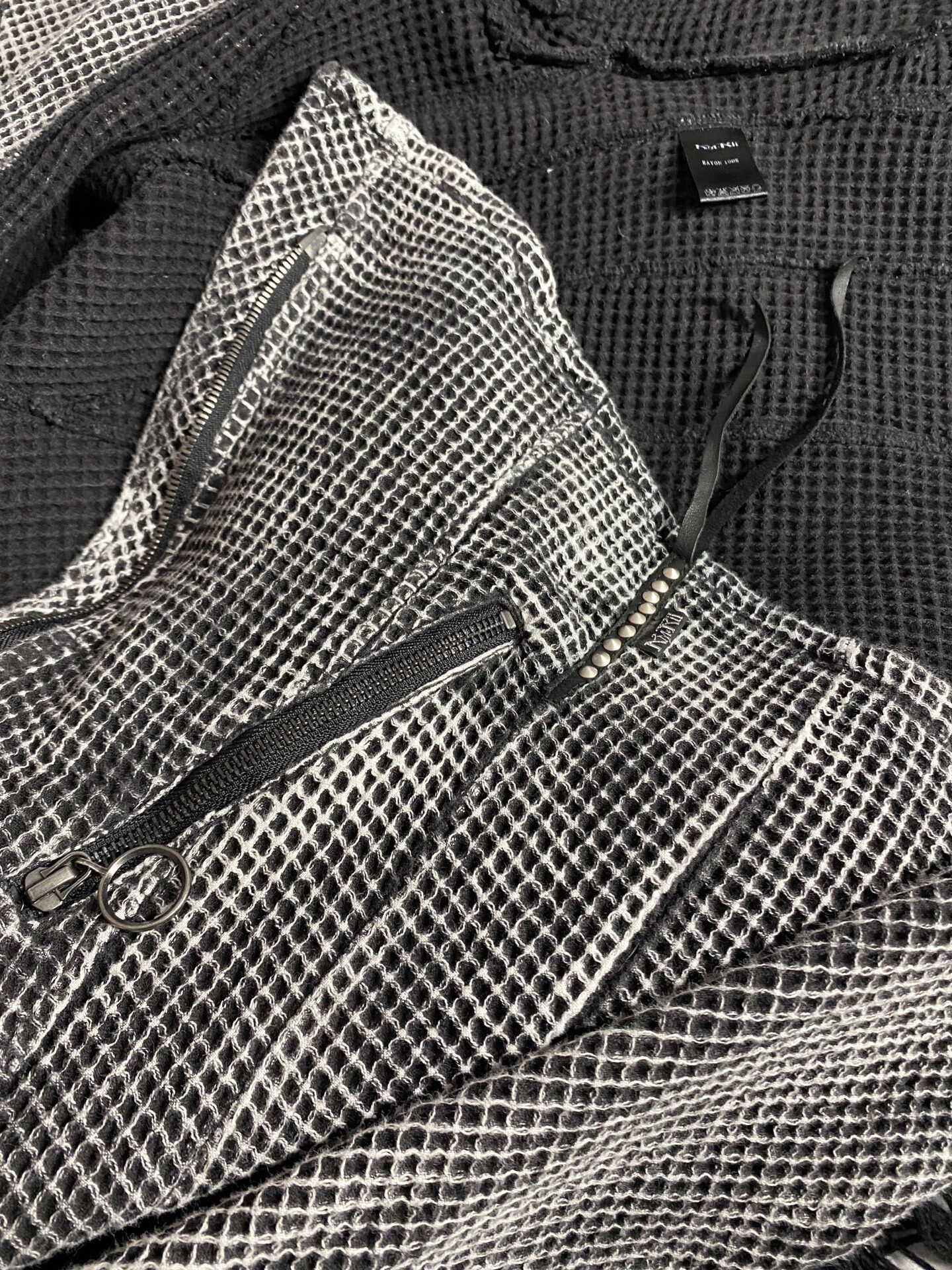 Kmrii Dark Grid-Patterned Jacket — label