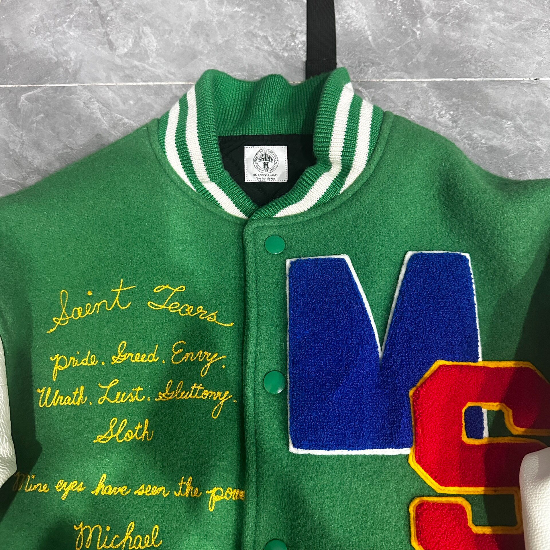 Saint Michael Graffiti Cross Varsity Jacket — back