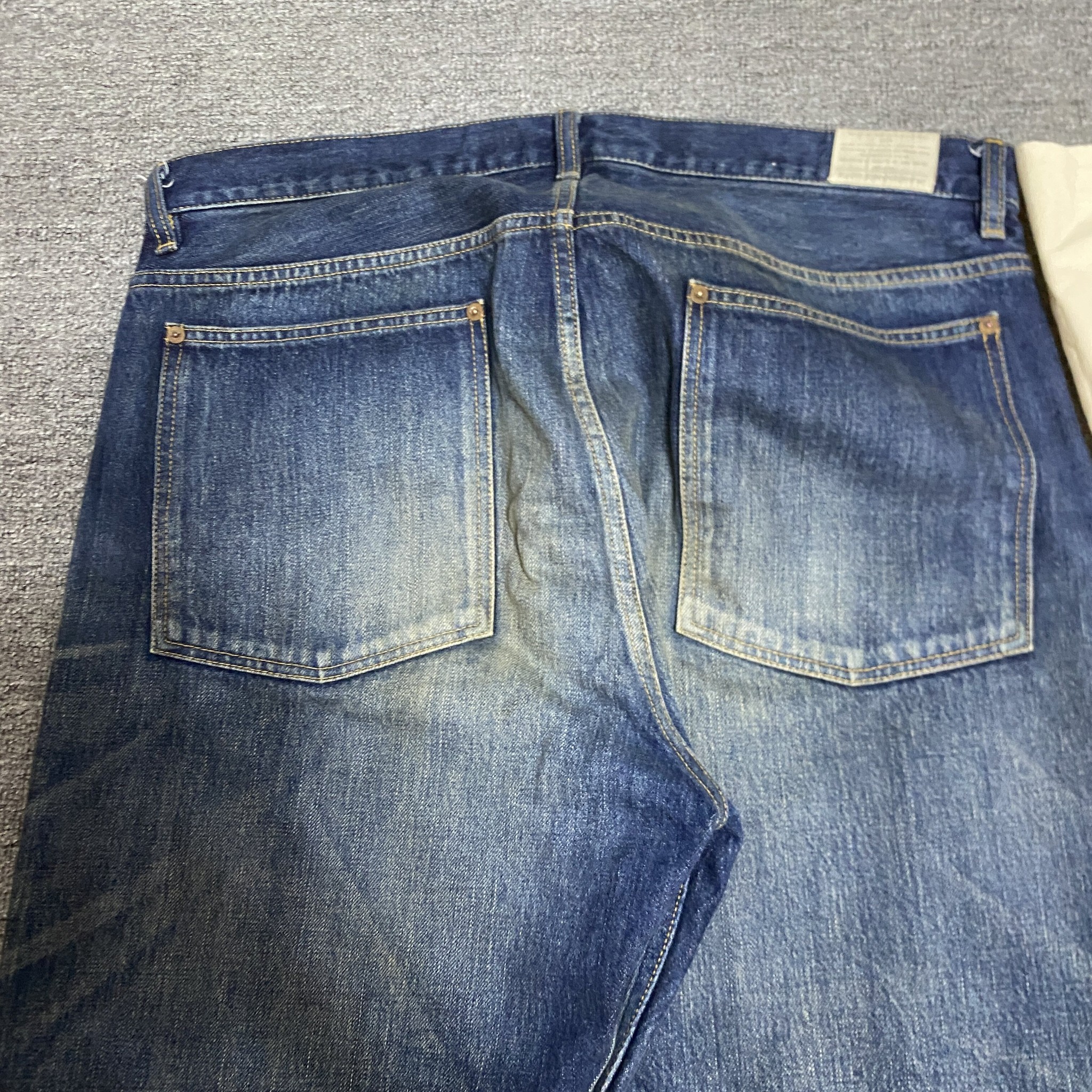 MADNESS 23AW Washed Denim Jeans — label