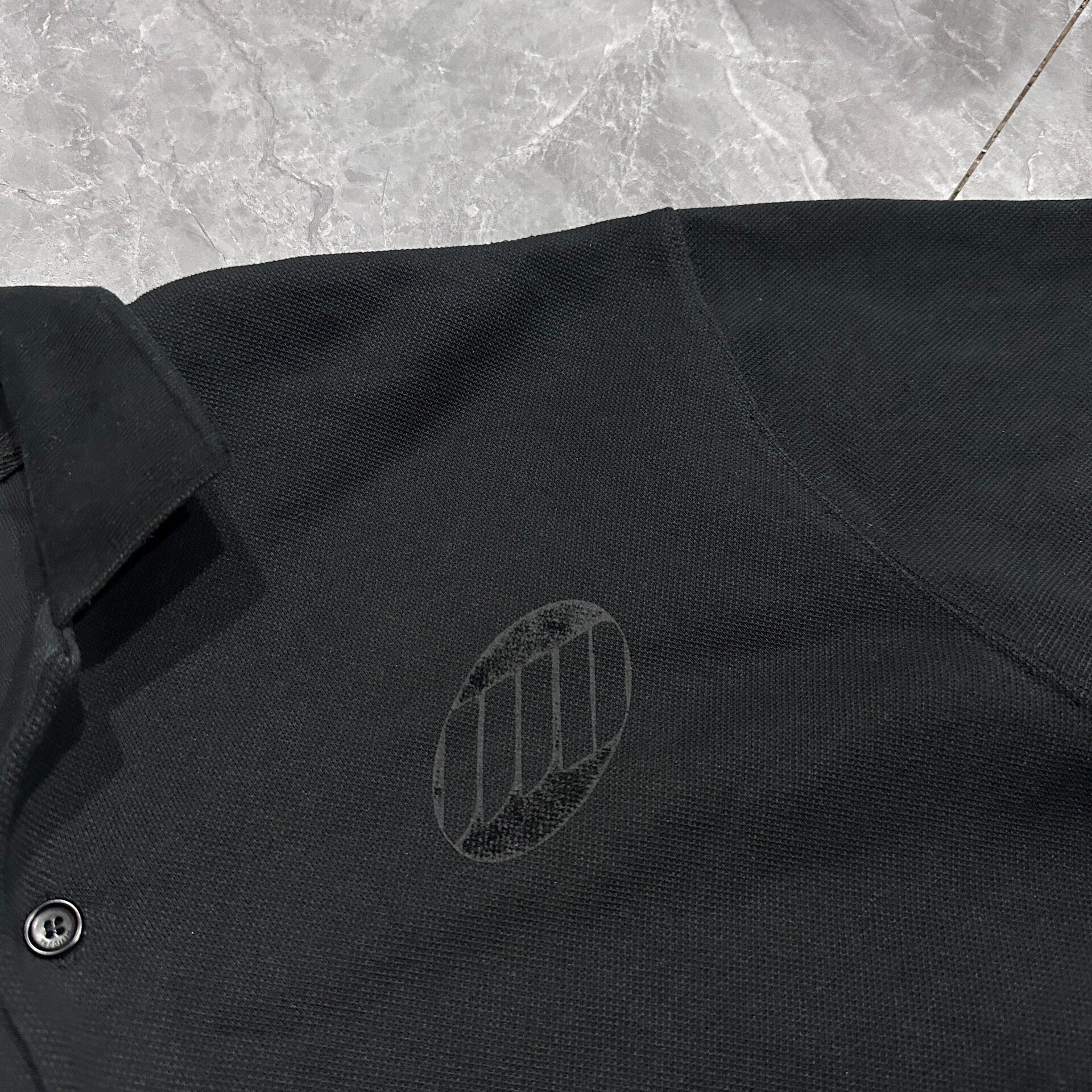 WE11DONE SS22 Unisex Logo Polo Shirt — detail