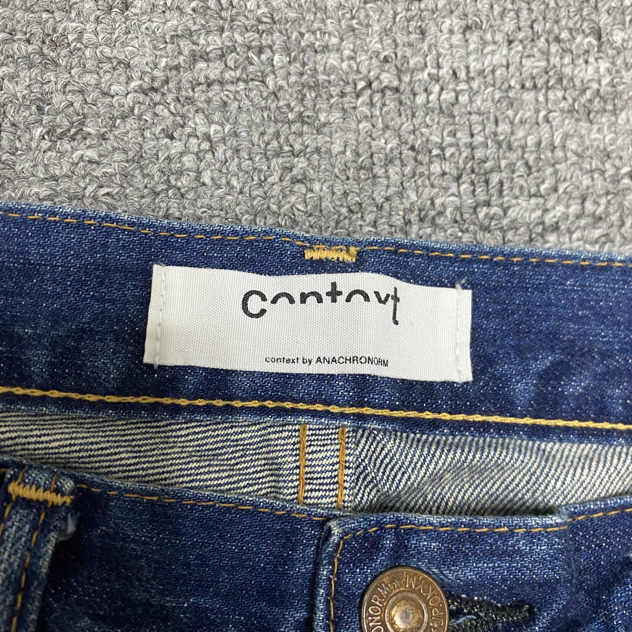 ANACHRONORM Baggy Washed Denim Jeans — label