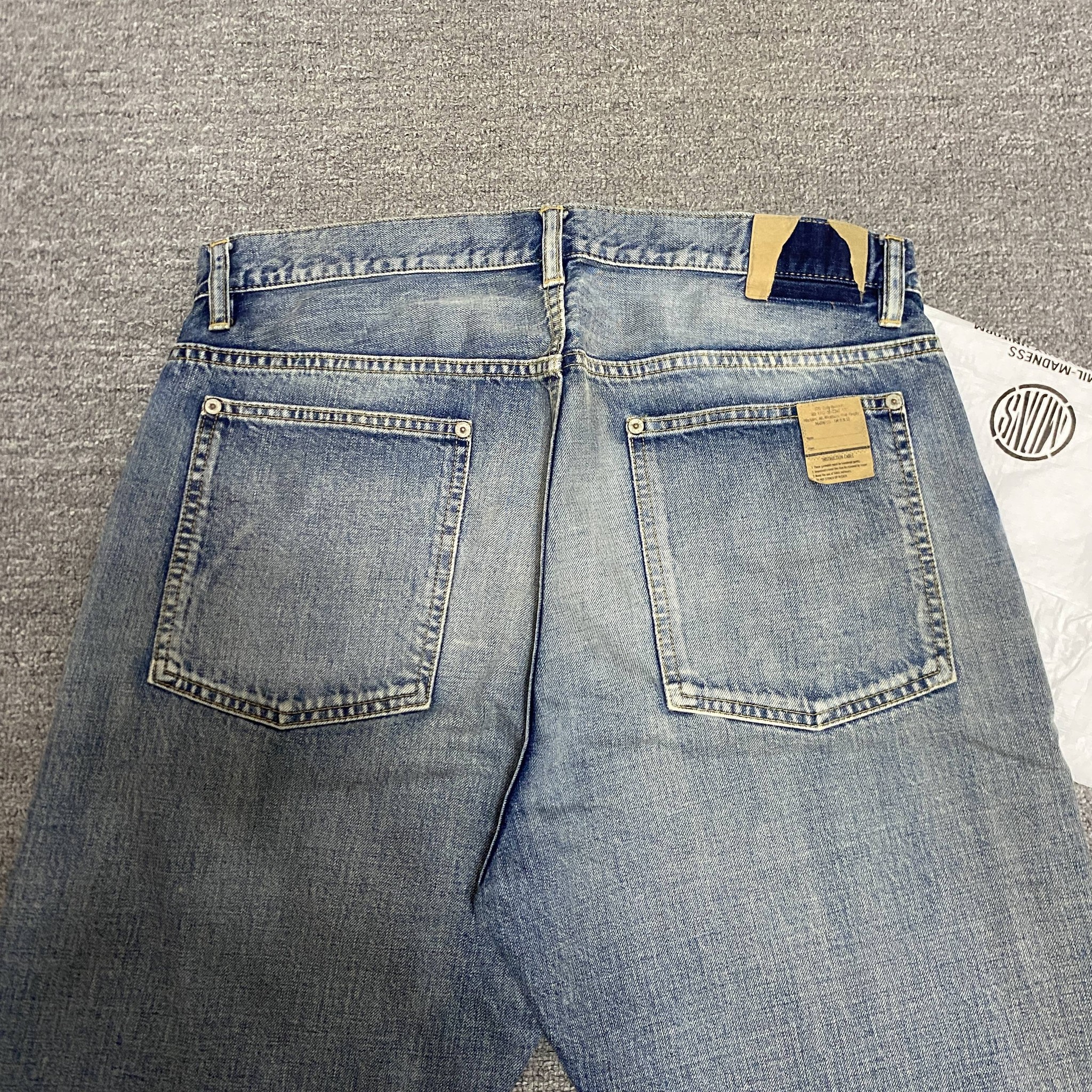 MADNESS 22SS Knee Rip Denim Jeans — back