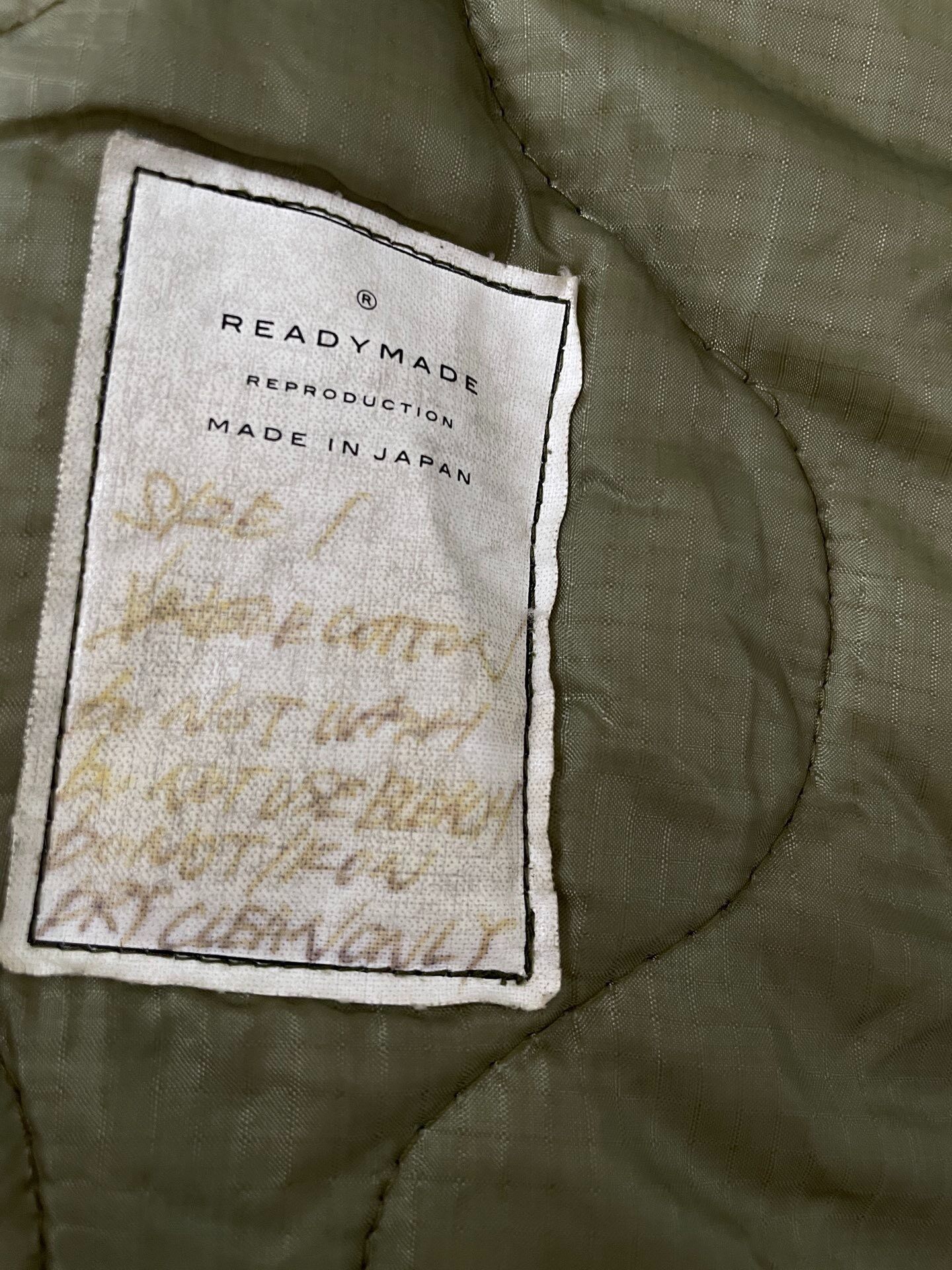 Olive Green Long Fishtail Parka — label