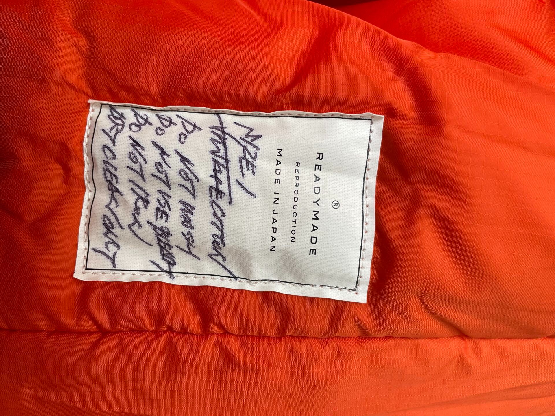 Olive Green Parka With Orange Lining — label
