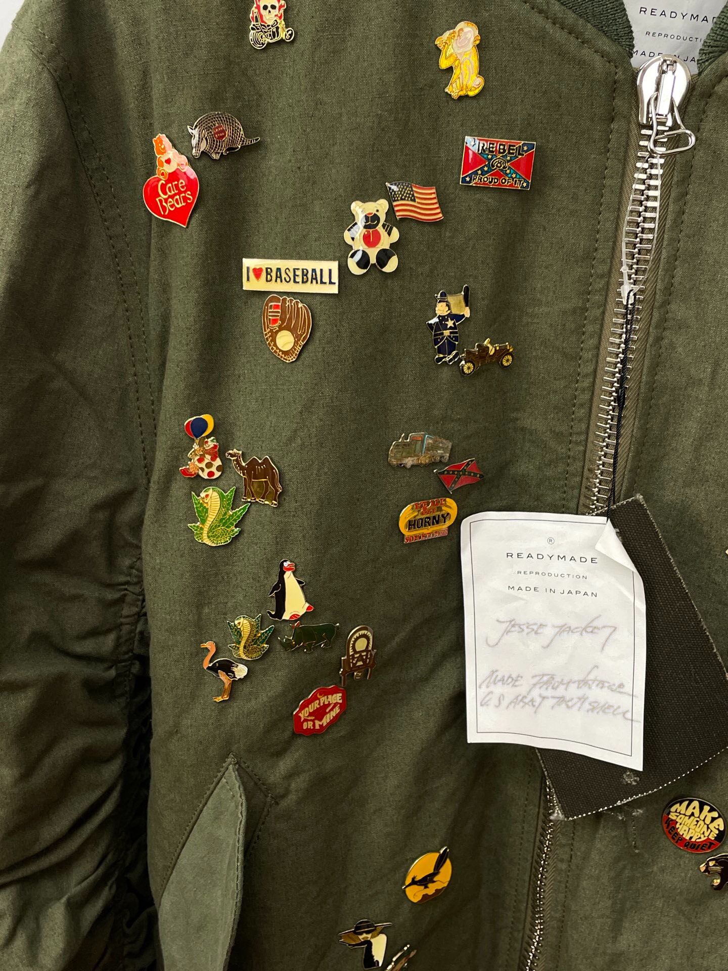 Readymade Olive Green Enamel Pin Bomber Jacket — label