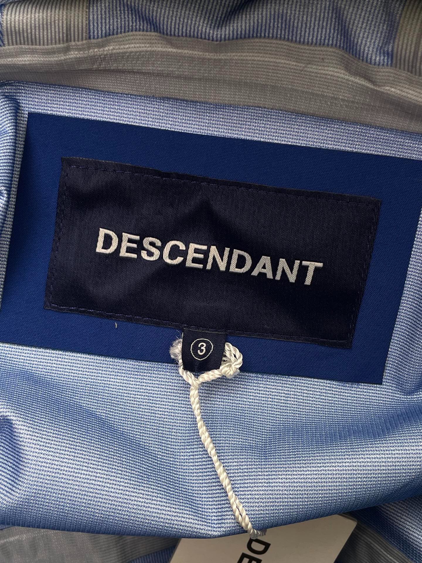 Descendant Blue Small Whale Windbreaker Jacket — label