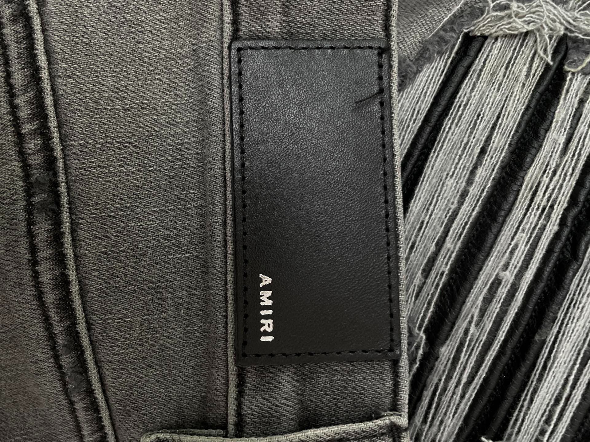 AMIRI MX1 Classic Gray Distressed Jeans — label
