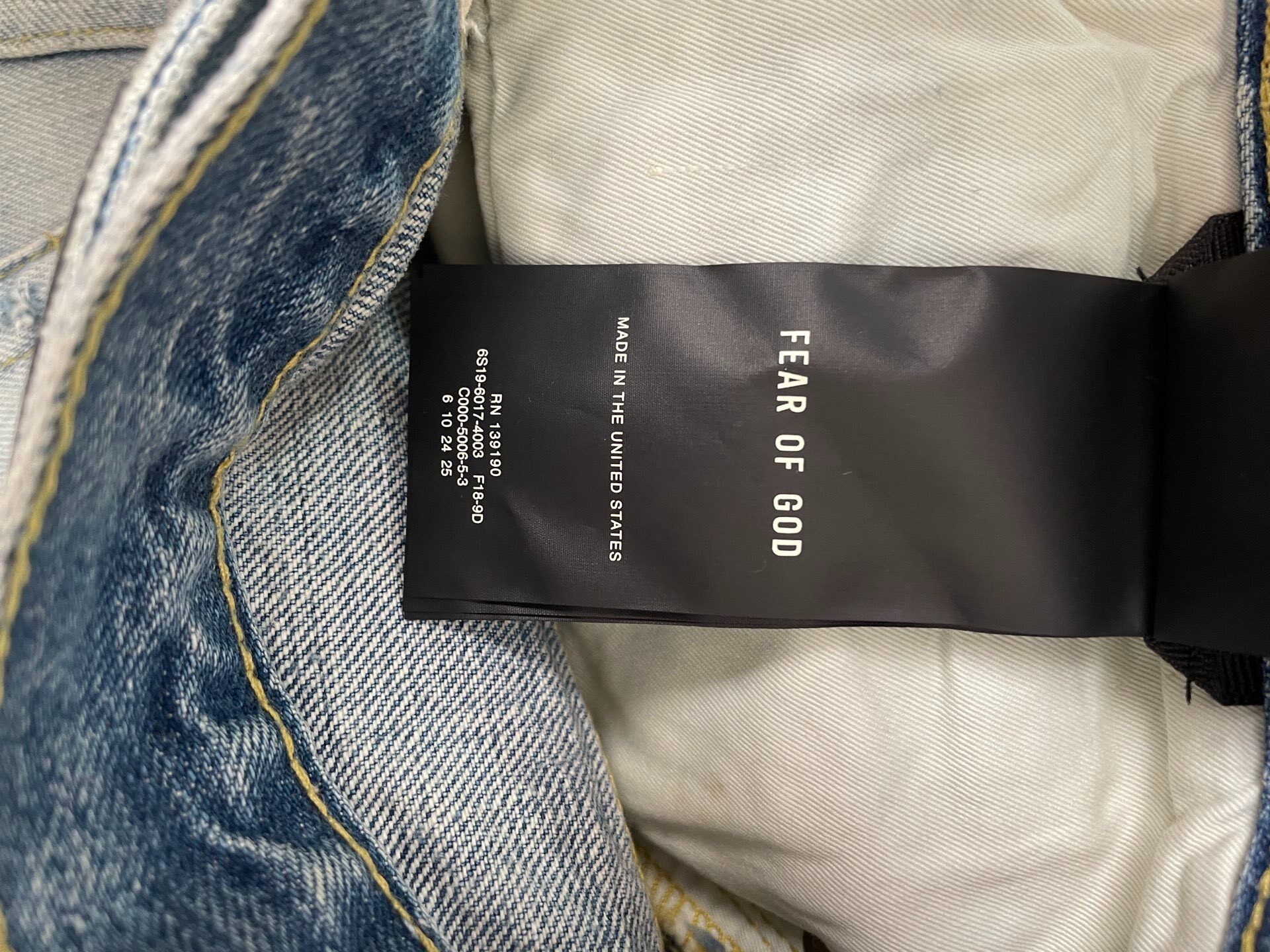 Fear of God 6th Light Blue Distressed Jeans — label
