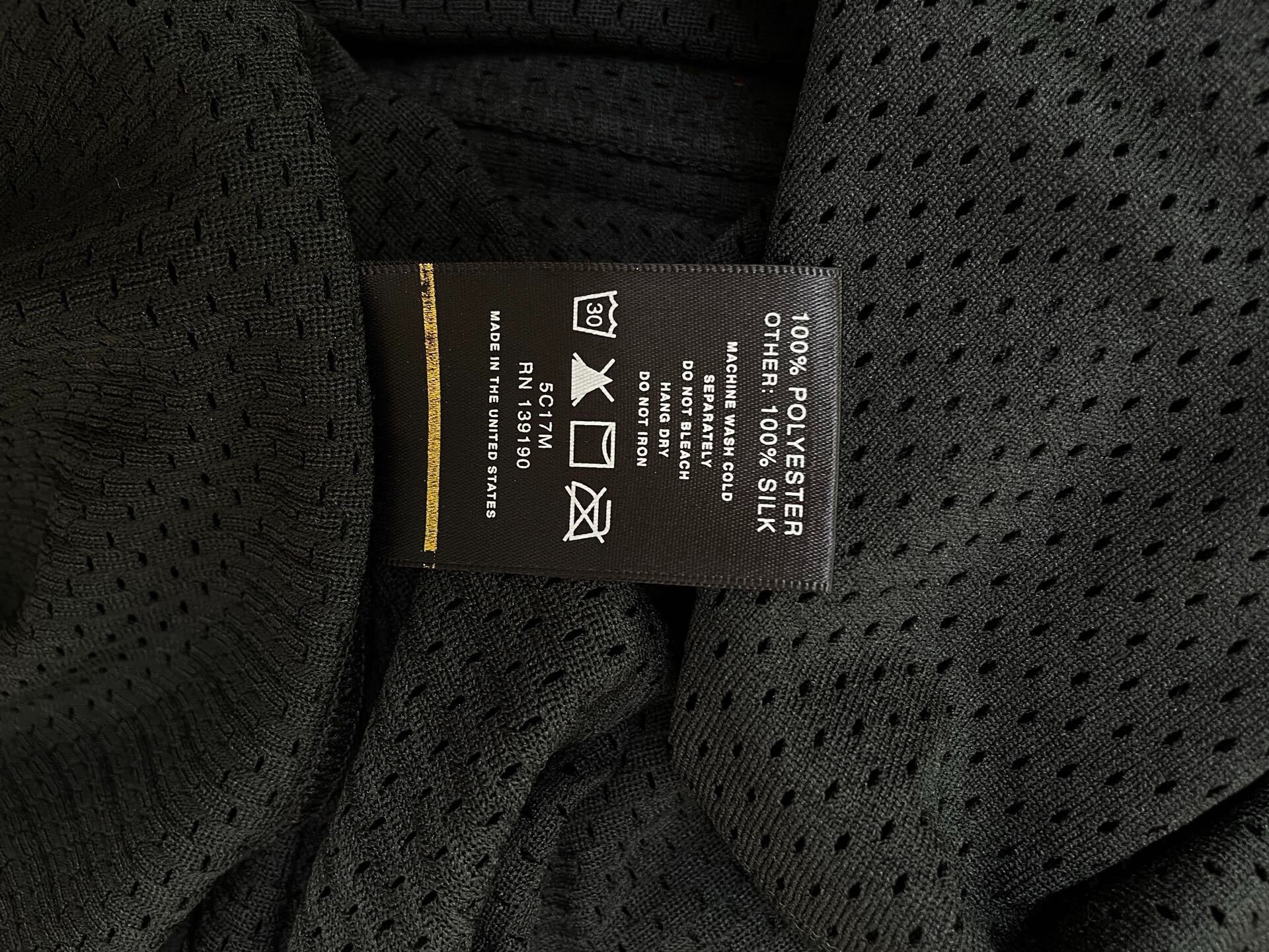 Fear of God Black Mesh Short Sleeve Tee — label